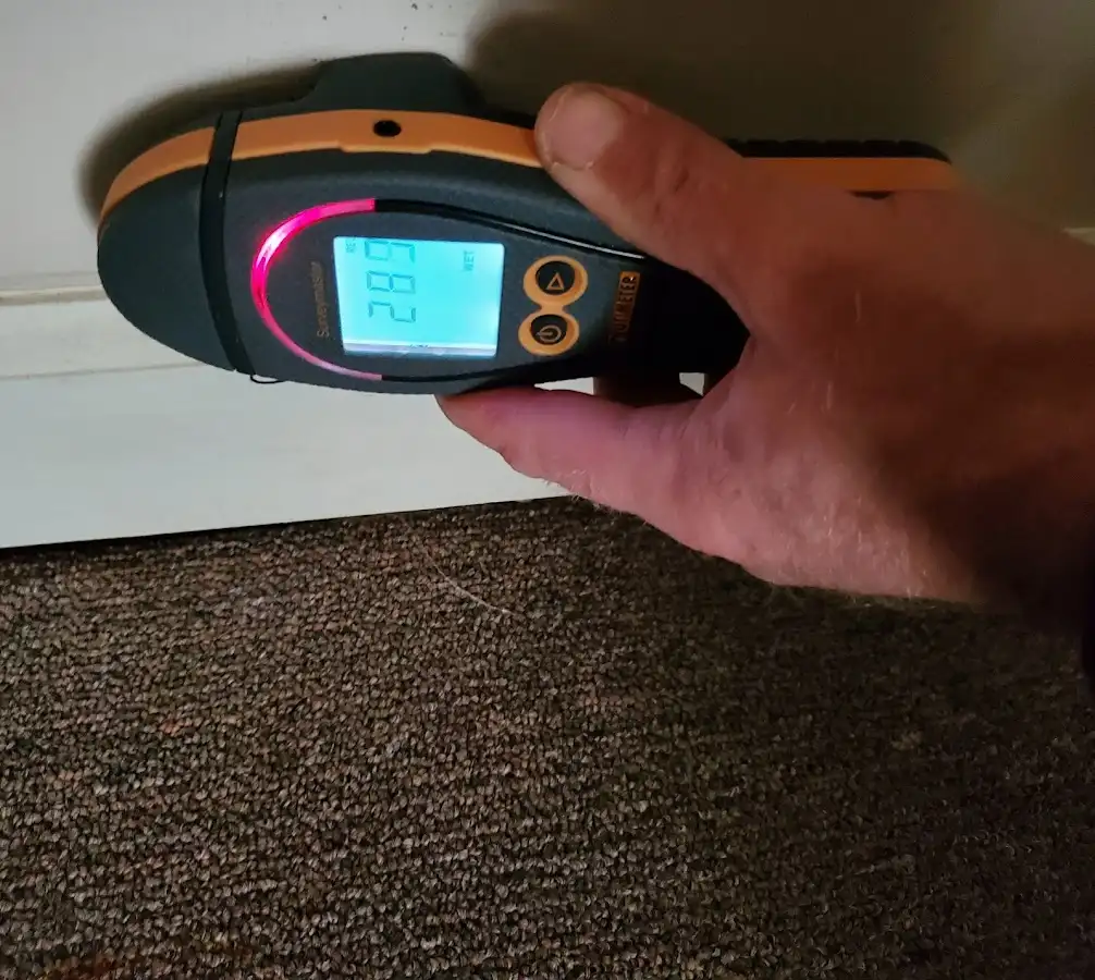 Moisture detection at baseboard during Storm Damage Restoration in Bowie